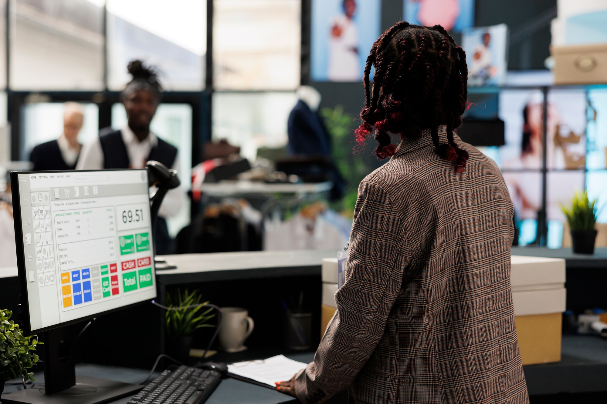 Showroom worker standing at cash register